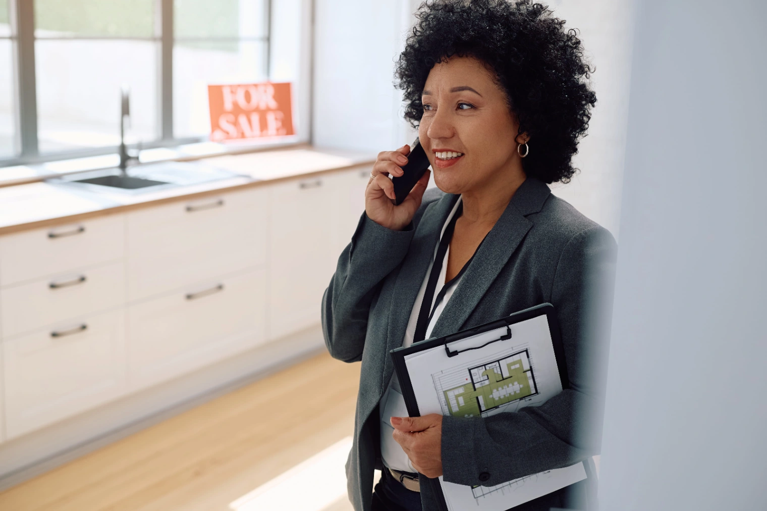 smiling-real-estate-agent-talking-on-the-phone-whi-2026-01-09-12-24-38-utc (1).jpg