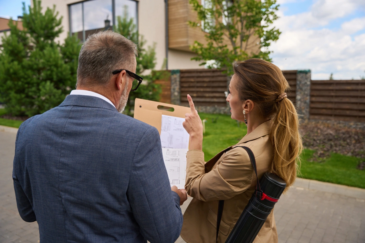 female-real-estate-agent-shows-blueprint-of-house-2026-01-09-00-58-44-utc (1).jpg
