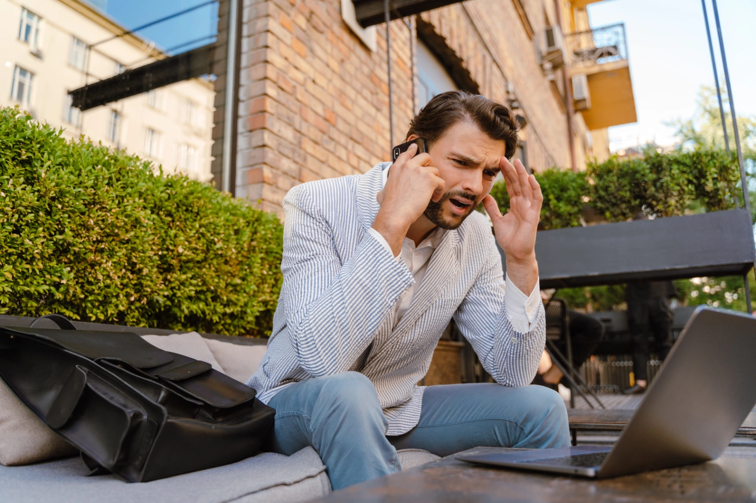 young-man-with-headache-talking-on-mobile-phone-wh-2026-03-19-05-07-42-utc (1).jpg